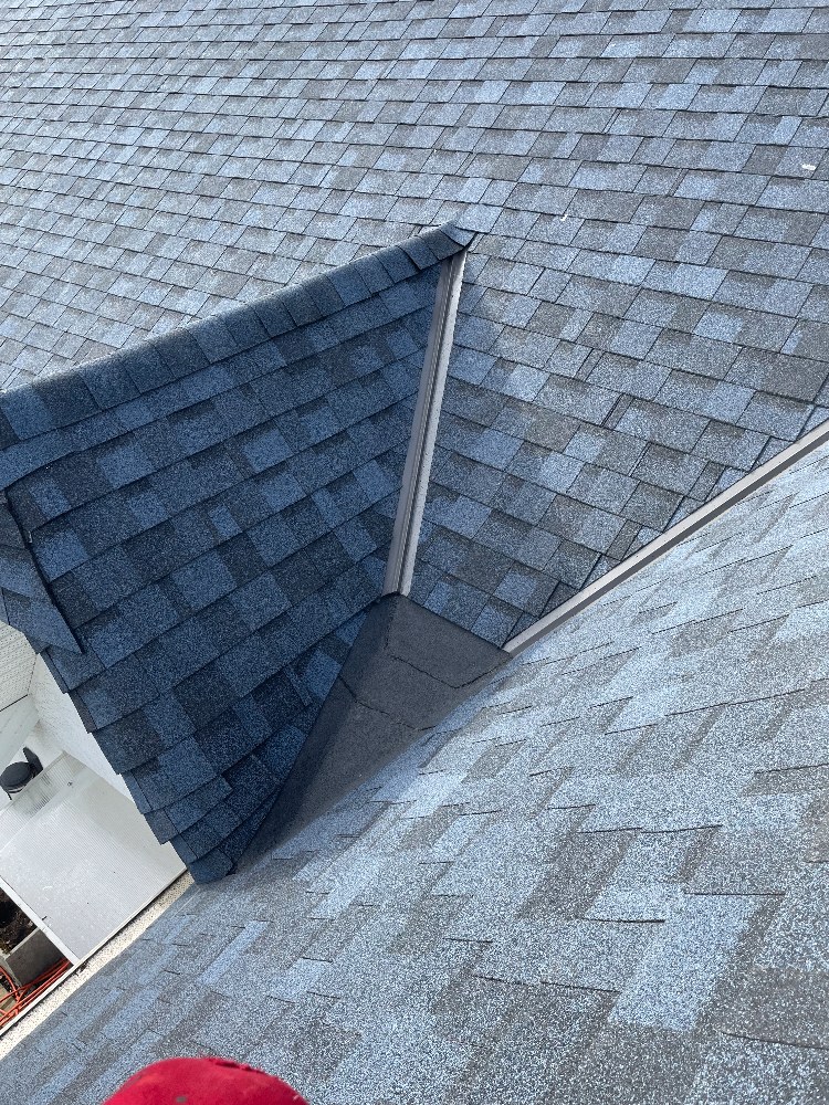Close view of a shingle valley and dormer transition